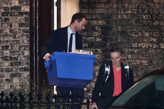 A person carrying a box leaves the home of Lord Peter Mandelson in northwest London.